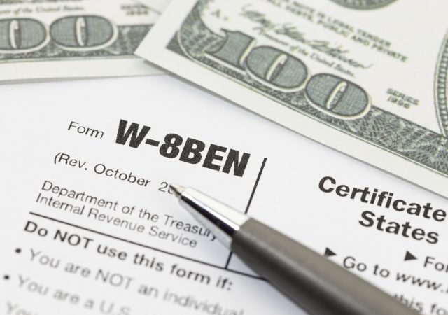 Close up of a W 8BEN form. Business Form W-8BEN Certificate of Foreign Status of Beneficial Owner for United States Tax Withholding and Reporting